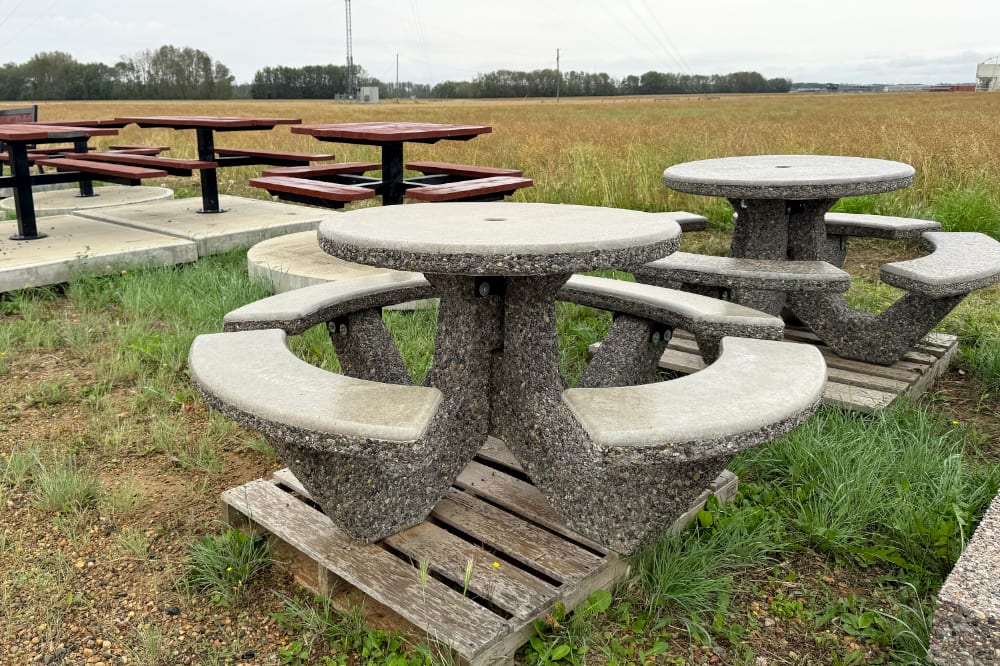 Precast concrete picnic table, park bench and planter on gravel